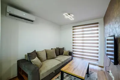 a living room with a couch and a table at Apartmani Sloboda in Belgrade