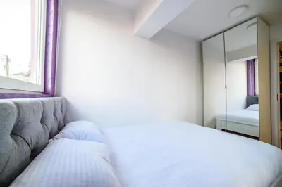 a bedroom with a bed and a mirror at Apartmani Sloboda in Belgrade