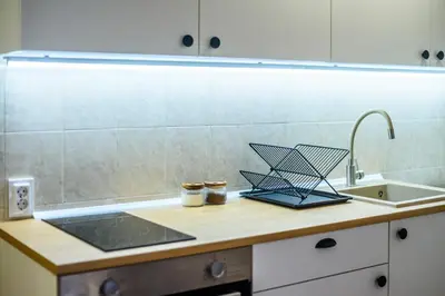 a kitchen counter with two jars and a sink at Apartmani Sloboda in Belgrade