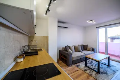 a living room with a couch and a table at Apartmani Sloboda in Belgrade