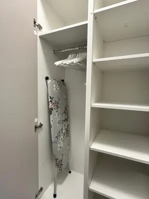 a walk in closet with white shelves at Dorcol Dream Apartment City View Terrace in Belgrade