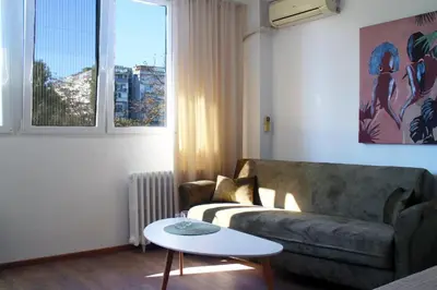 a living room with a couch and a table at Gavrila Principa Apartment in Belgrade