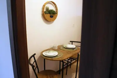 a small table with chairs and plates on it at Gavrila Principa Apartment in Belgrade