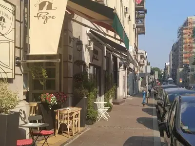 a street with tables and chairs and a building at Central apt Jovanova in Belgrade