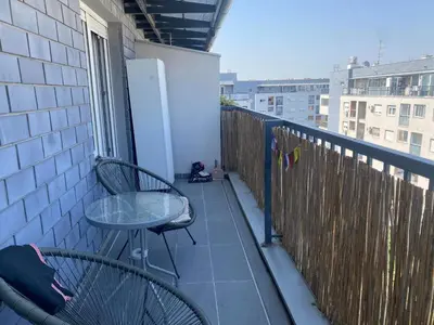 a balcony with two chairs and a table on a balcony at Boba in Belgrade