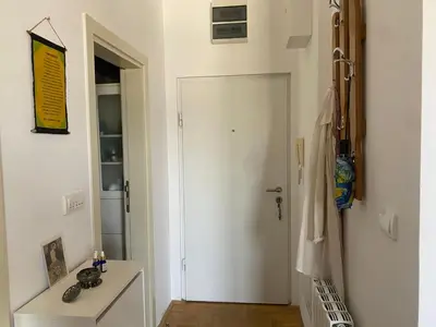 a hallway with a white door and a table at Boba in Belgrade