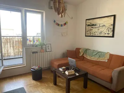 a living room with a couch and a table with a laptop at Boba in Belgrade