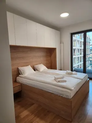 a bedroom with a large bed with white sheets at Novi Dorcol Big in Belgrade