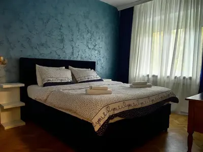 a bedroom with a bed with two towels on it at Apartman Cetkovic in Belgrade