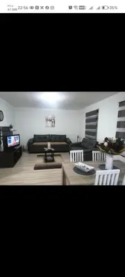 a living room with a couch and a table and chairs at Sveti Luka- OBRADOVIĆ SOKAK 41 in Šimanovci