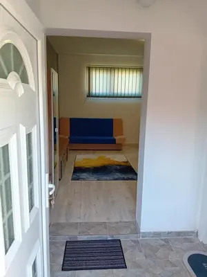a hallway with a blue couch in a room at AlejaPark in Železnicka Stanica Inđija Selo