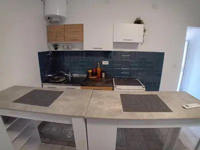 a kitchen with a counter top in a room at AlejaPark in Železnicka Stanica Inđija Selo