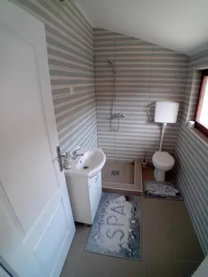 a bathroom with a sink and a toilet at AlejaPark in Železnicka Stanica Inđija Selo
