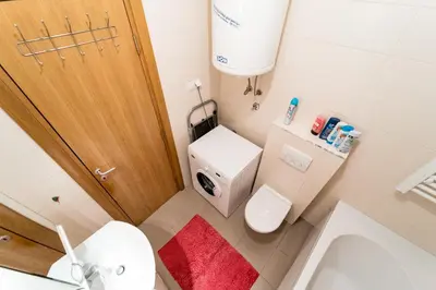 a small bathroom with a toilet and a sink at Apartment with balcony in Belgrade