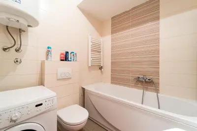 a bathroom with a tub and a toilet and a sink at Apartment with balcony in Belgrade
