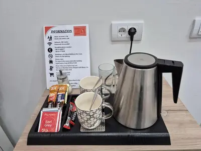 a tea kettle and cups on a counter at Authentic Belgrade Centre - 7 suites for 15 Guests, with patios in courtyard for smokers in Belgrade