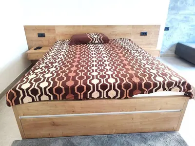 a bed in a bedroom with a wooden frame at Asja studio in Belgrade
