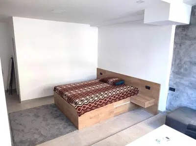a bedroom with a bed in a room at Asja studio in Belgrade