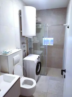 a bathroom with a toilet and a glass shower at Asja studio in Belgrade