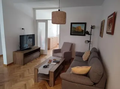 a living room with a couch and a tv at Tesla apartment - lovely 2 bedroom apartment in Belgrade