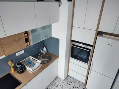 a small kitchen with a sink and a microwave at Tesla apartment - lovely 2 bedroom apartment in Belgrade