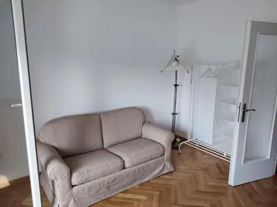 a living room with a couch and a lamp at Tesla apartment - lovely 2 bedroom apartment in Belgrade