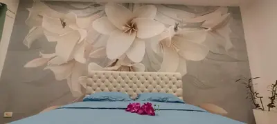 a bedroom with a bed with flowers on the wall at Venera Lux Apartman in Zemun