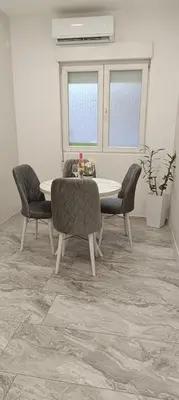 a dining room with a table and chairs at Venera Lux Apartman in Zemun