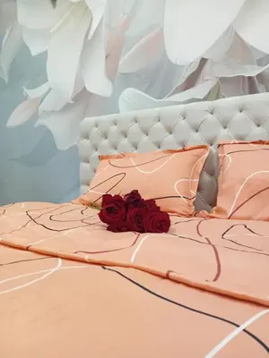a bed with a bouquet of red roses on it at Venera Lux Apartman in Zemun