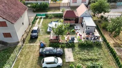 an aerial view of a house with cars parked in a yard at Apartman255 in Slankamenački Vinogradi