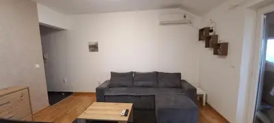 a living room with a couch and a table at Apartman EXPO Surčin in Surčin