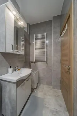 a bathroom with a sink and a mirror and a shower at Jordan Belgrade Apartment in Belgrade