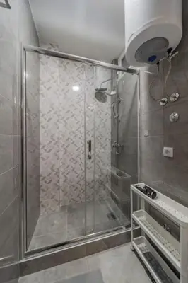 a shower with a glass door in a bathroom at Jordan Belgrade Apartment in Belgrade
