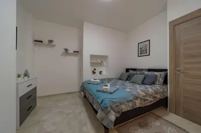 a bedroom with a bed and a dresser in it at Jordan Belgrade Apartment in Belgrade