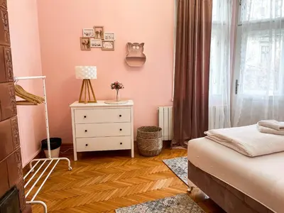 a bedroom with a bed and a dresser and a window at Lukerly 1 in Belgrade