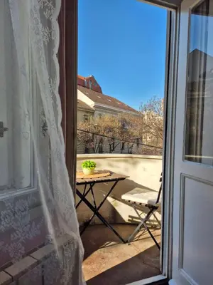 an open door to a patio with a table and a chair at Lukerly 1 in Belgrade