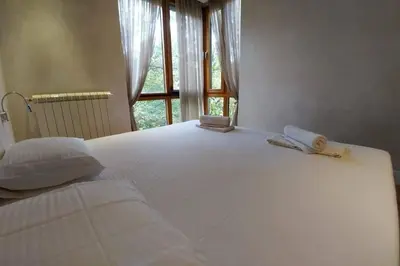 a large white bed with two towels on top of it at Belgrade Center Apartment Lux 2 in Belgrade