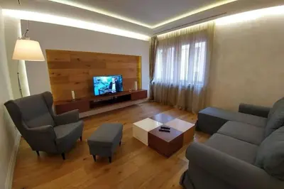 a living room with a couch and chairs and a tv at Belgrade Center Apartment Lux 2 in Belgrade