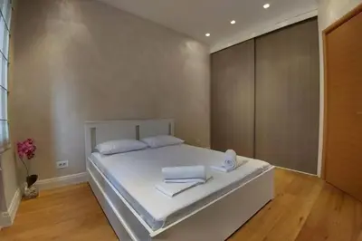 a bedroom with a large white bed with towels on it at Belgrade Center Apartment Lux 2 in Belgrade