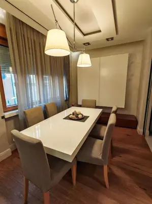 a dining room with a white table and chairs at Belgrade Center Apartment Lux 2 in Belgrade