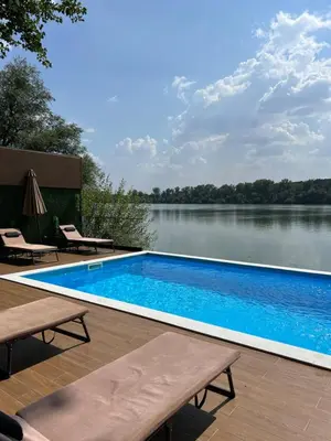 a swimming pool with a view of a lake at Riverhouse PIER in Beograd