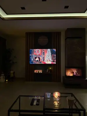 a living room with a tv and a glass table at Riverhouse PIER in Beograd