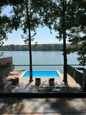 a swimming pool with a view of a river at Riverhouse PIER in Beograd