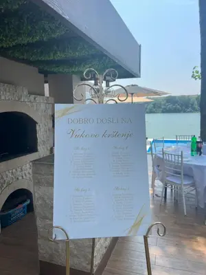 a sign for a restaurant with a view of the water at Riverhouse PIER in Beograd