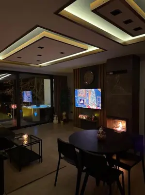 a living room with a table and chairs and a tv at Riverhouse PIER in Beograd
