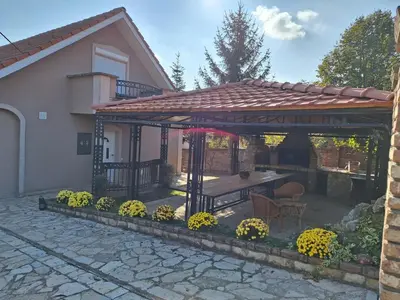 a gazebo with a table in a yard at Naša priča in Belgrade