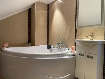 a bathroom with a white tub and a sink at Naša priča in Belgrade