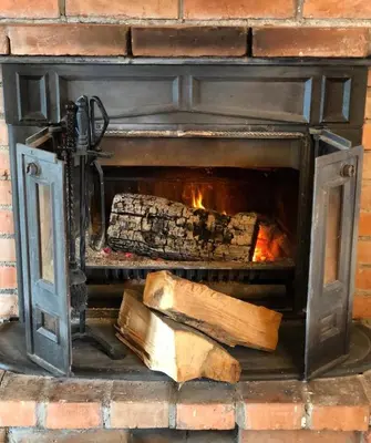 a brick fireplace with logs in it at Naša priča in Belgrade