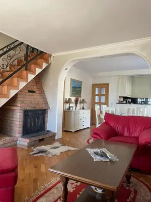 a living room with a red couch and a fireplace at Naša priča in Belgrade