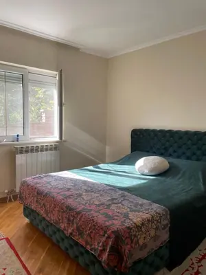 a bedroom with a bed and a window at Naša priča in Belgrade